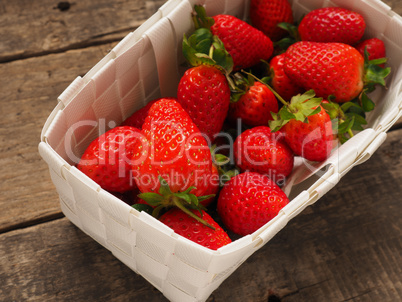 Fresh organic strawberries in a white basket