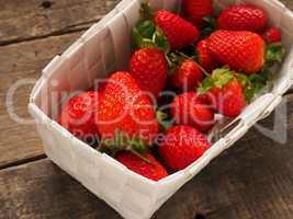 Fresh organic strawberries in a white basket