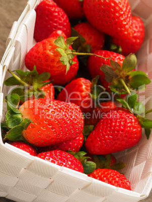 Fresh organic strawberries in a white basket