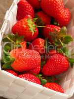 Fresh organic strawberries in a white basket