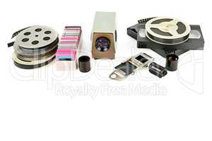 Old videocassettes and video projector with slides isolated on w