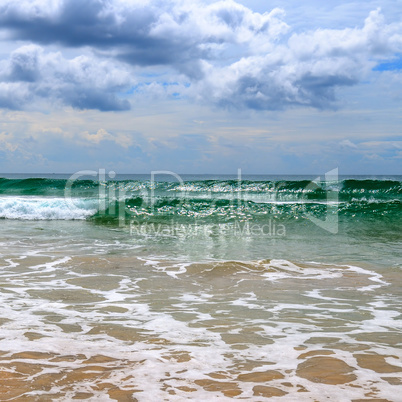 Sandy beach. Dramatic cloudscape with heavy rain and tropical st