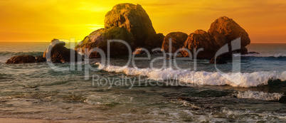 Sea landscape with rocky island and the sunrise. Wide photo.