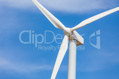 Single Wind Turbine Over Dramatic Blue Sky