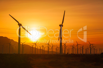 Silhouetted Wind Turbines Over Dramatic Sunset Sky