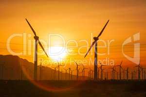 Silhouetted Wind Turbines Over Dramatic Sunset Sky