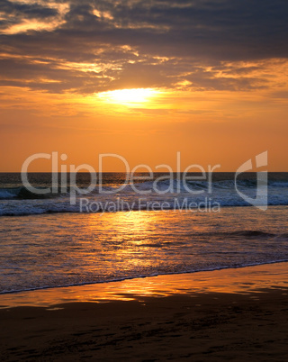 Beach of the ocean and golden sun rise.