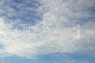 Blue sky background with tiny clouds