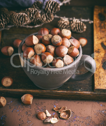 hazelnut in a shell in a brown clay cup