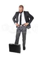 Businessman standing thinking looking down