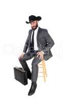 Business man sitting with hat and briefcase
