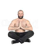 A shirtless man sitting doing yoga with a beard