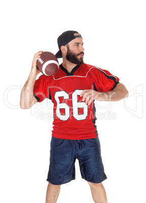 A football player in his jersey throwing the ball
