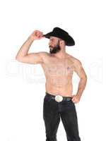 Shirtless man with a cowboy hat, looking away