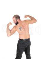 Man standing from back shirtless with a tattoo