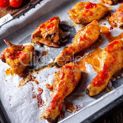 Rustic backed chicken wings,legs on baking tray