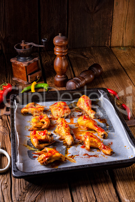 Rustic backed chicken wings,legs on baking tray