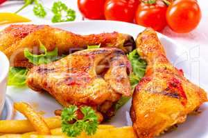 Grilled chicken wings,legs,chips and vegetables