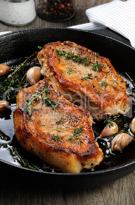 Roasted pork steak in frying pan