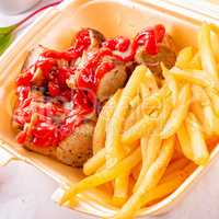 grilled bratwurst with French fries and ketchup