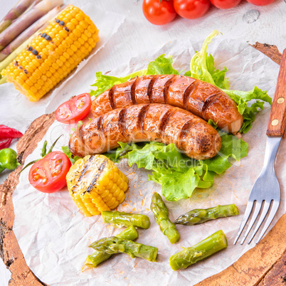 grilled krakauer sausage with boiled corn and green salad