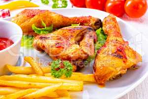 Grilled chicken wings,legs,chips and vegetables