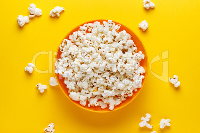 Popcorn in an orange bowl.