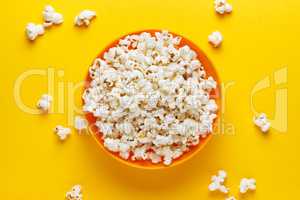 Popcorn in an orange bowl.