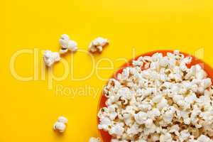 Popcorn in an orange bowl.