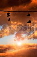 Sneakers hanging at sunset