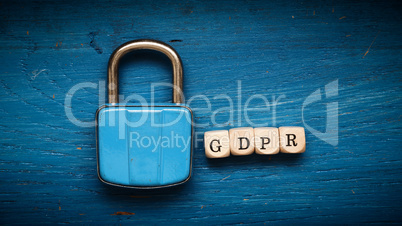 Old used padlock on a blue rustic with gdpr