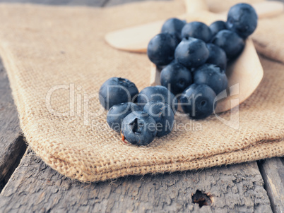 Fresh blueberries on a wooden spoon