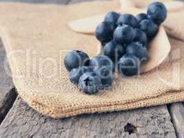 Fresh blueberries on a wooden spoon