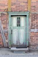 weathered, green wooden door