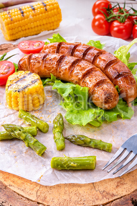 grilled krakauer sausage with boiled corn and green salad