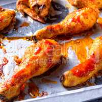 Rustic backed chicken wings,legs on baking tray