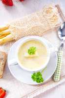 asparagus cream soup with capers and fresh baguette