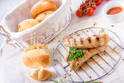 delicious bratwurst with ketchup and fresh rolls