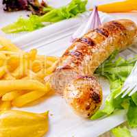 delicious grilled bratwurst with fries and mustard