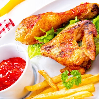Grilled chicken wings,legs,chips and vegetables