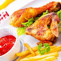 Grilled chicken wings,legs,chips and vegetables