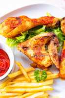 Grilled chicken wings,legs,chips and vegetables