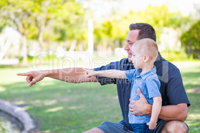 Young Caucasian Father and Son Having Fun At The Park