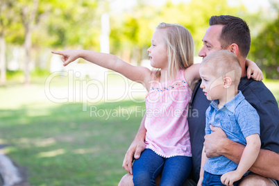 Young Caucasian Dad, Son and Daughter Having Fun In The Park