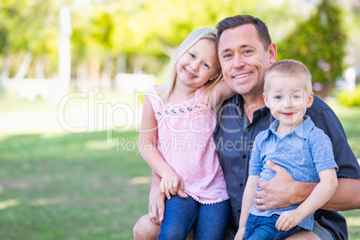 Young Caucasian Dad, Son and Daughter Having Fun In The Park
