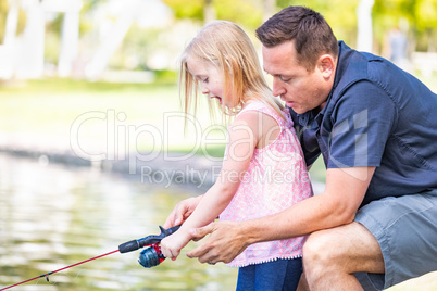 Young Caucasian Father and Daughter Having Fun Fishing At The La