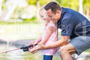 Young Caucasian Father and Daughter Having Fun Fishing At The La