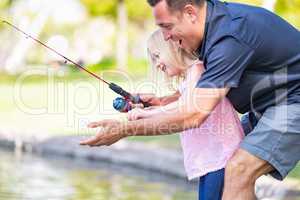 Young Caucasian Father and Daughter Having Fun Fishing At The La