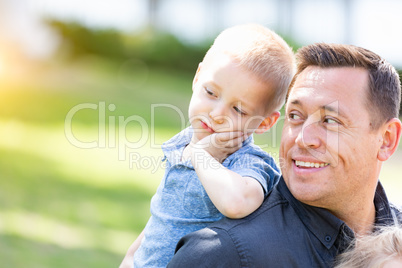 Young Caucasian Father and Son Having Fun At The Park