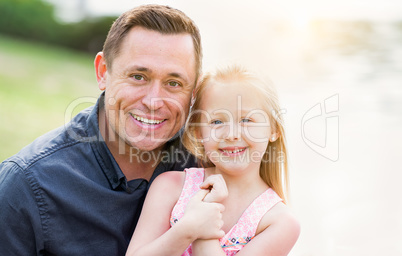 Young Caucasian Father and Daughter Having Fun At The Park